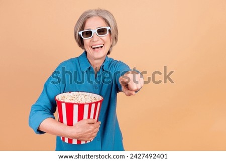 Photo of funky woman with bob hairdo dressed blue shirt in 3d glasses hold popcorn directing at you isolated on pastel color background