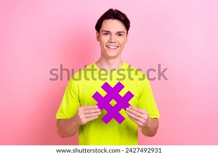Photo portrait of handsome teen male hashtag number symbol dressed stylish yellow garment isolated on pink color background