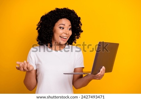 Photo of attractive woman with perming coiffure dressed white t-shirt talk on remote meeting on laptop isolated on yellow color background