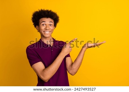 Photo of satisfied glad man wear trendy violet polo recommend new product low price sale empty space isolated on yellow color background Royalty-Free Stock Photo #2427493527
