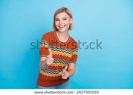 Photo of flirty coquettish adorable woman with bob hairdo dressed knit t-shirt indicating at you isolated on blue color background