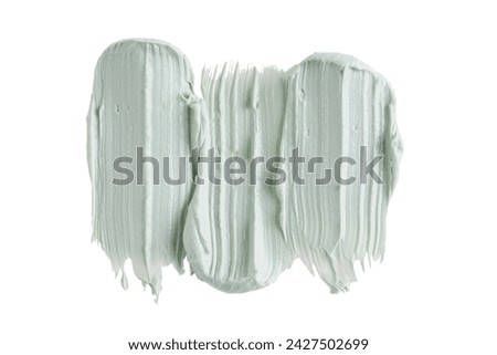 Green clay mask or correcting concealer smear smudge isolated on white background. Cream texture. Facial mask, skincare beauty product swatch closeup. SPA background Royalty-Free Stock Photo #2427502699