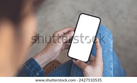 Cell phone white screen mockup, woman's hands holding mobile phone with blank screen on thigh and, overhead view. space for advertise, social media marketing design