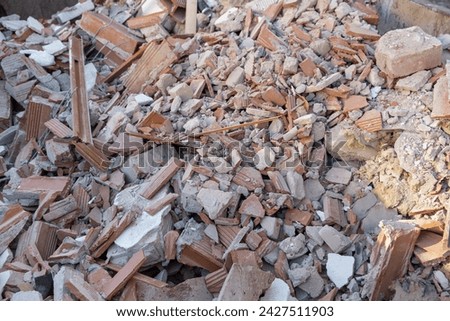 Shattered, broken construction waste after building demolition,in a construction waste container. A collection service is available to handle the disposal of these materials. Royalty-Free Stock Photo #2427511903