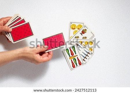 Culture and Entertainment: Dealing Cards from a Spanish Deck of Cards Royalty-Free Stock Photo #2427512113