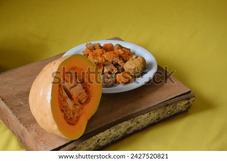 Delicious pumpkin with dried meat served on a white porcelain plate. Typical Brazilian cuisine recipe, pumpkin cooked medium rare with meat and copy space