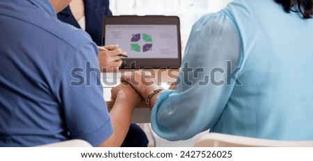 Young asian woman counseling to elderly couple husband and wife about insurance life for planning in living room at home, insurance life agent or consultant explaining with senior for decisions. Royalty-Free Stock Photo #2427526025