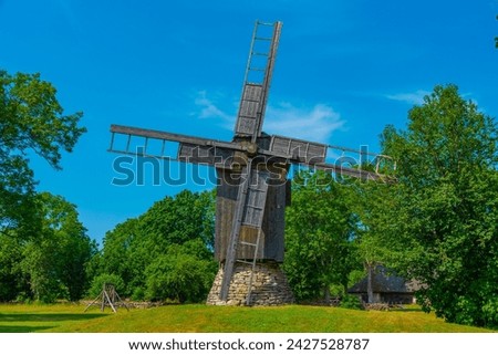 Wooden windmill at Mihkli farmstead museum in Estonia. Royalty-Free Stock Photo #2427528787