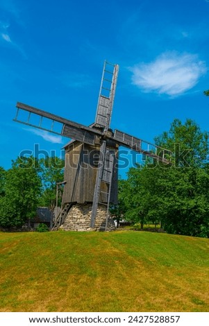 Wooden windmill at Mihkli farmstead museum in Estonia. Royalty-Free Stock Photo #2427528857