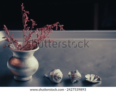 Dried flowers in silver vase, vintage style room decoration, copy space.