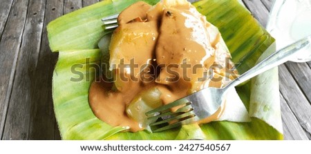 RUJAK PETIS typical of Paciran Lamongan, consisting of sliced ​​cucumber, star fruit, pineapple, jicama, eggplant. and doused with PETIS chili sauce it tastes spicy, sweet and fresh. Royalty-Free Stock Photo #2427540567