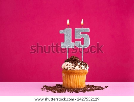 Birthday cupcake with candle number 15 - Birthday card on pink background