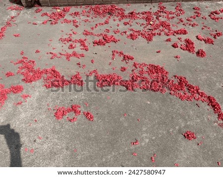 Exterior close up top view photo visual of the remains red crackers than have already exploded during the Chinese new year time to sacre bad luck spirits away to bring good luck and prosperity