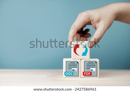 Convert DOC document files to PDF with program. File symbol icon on wooden block. Concept of technology platform for converting documents into portable document formats.