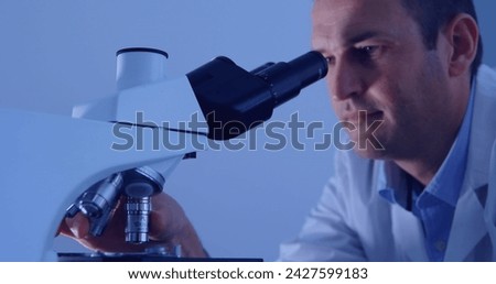 Image of data processing over caucasian male scientist using microscope. Global science, digital interface, computing and data processing concept digitally generated image.