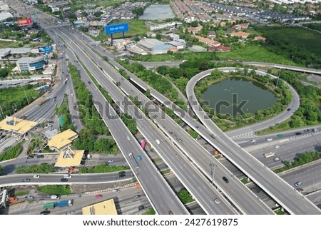 Aerial top view of smart transportation with Expressway, Road and Roundabout, multilevel junction traffic highway-Top view. Important infrastructure and transport in big city.