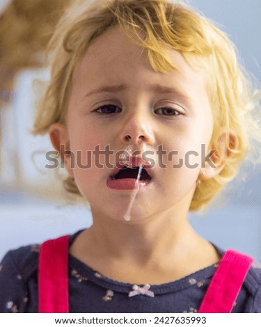 The child has snot, the child is crying. selective focus. Kid.