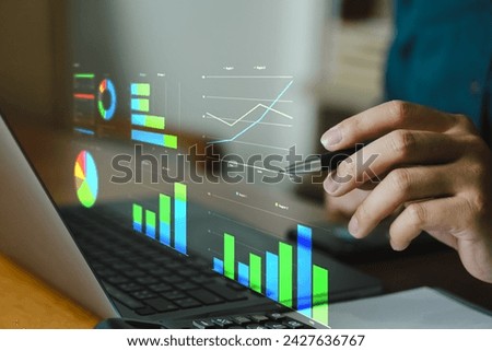 Business people using laptop with digital visual reality of graphics, graph investments for analysis market and demand.