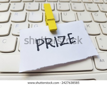 Prize writting on laptop keyboard background.