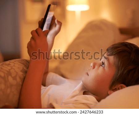 Boy, kid and tablet in bedroom at night for typing, reading or online game with app in family home. Child, bed and digital touchscreen for movie, cartoon and streaming subscription to relax in house