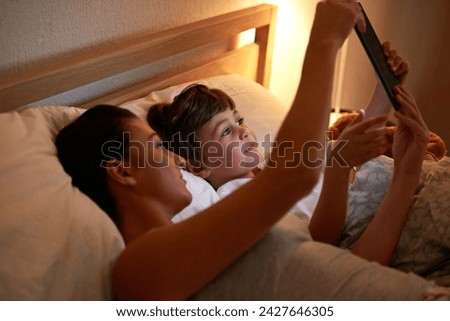 Mother, boy and tablet in bedroom at night for care, bonding or to watch movies together in family house. Mom, child and home on digital touchscreen for cartoon. film or streaming subscription in bed