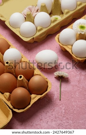 Eggs in a cardboard box with flowers.