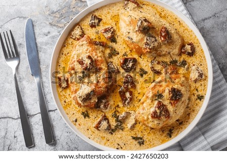 Marry Me Chicken, chicken breasts sauteed in cream sauce with sundried tomatoes, thyme, red pepper flakes closeup on the plate on the table. Horizontal top view from above
 Royalty-Free Stock Photo #2427650203