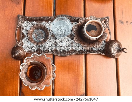 Traditional hot turkish coffee and turkish tea in glass. Retro copper coffee set. Retro copper coffee set in cafe outdoor. Top view. High quality photo