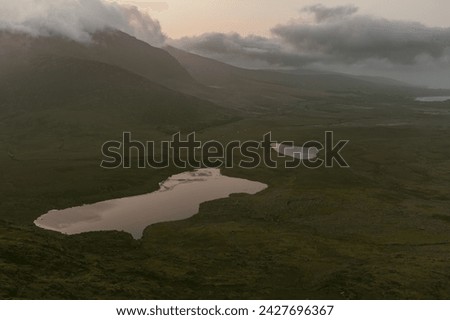 Conor Pass, one of the highest Irish mountain passes served by an asphalted road, located on the south-western end of the Dingle Peninsula, County Kerry, Ireland Royalty-Free Stock Photo #2427696367