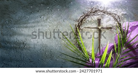 Lenten -  Crown Of Thorns and Cross With Purple Robe On Ash - Palm Leaves And Bloody Spikes For Penitence Concept With Abstract Sunlight Royalty-Free Stock Photo #2427701971
