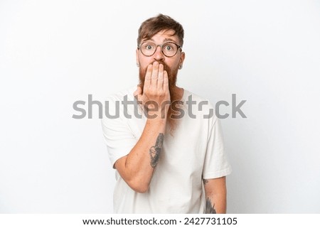 Redhead man with long beard isolated on white background covering mouth with hand