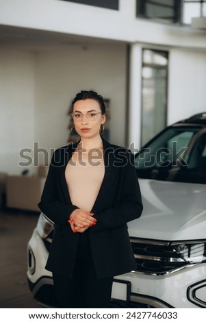 Professional salesperson working in car dealership. High quality photo