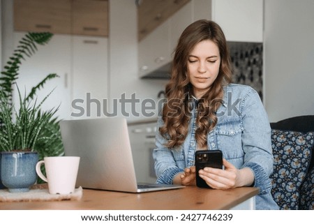 Happy smiling woman sitting on couch, couch and using laptop in living room at home, watching funny video, learning language, video calling, mother working online. Woman Working Online On Laptop 