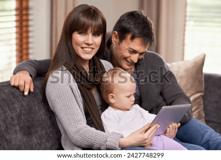 Digital, tablet or baby with parents on a sofa for cartoon, streaming or videos while bonding at home. Search, learning and family in living room with storytelling app, fantasy or child development