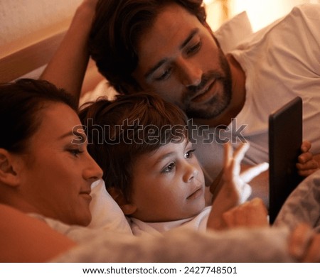 Parents, boy and tablet in bedroom at night for app, bonding and watch movies together in family house. Dad, mom and child in bed with touchscreen, cartoon or film with streaming subscription in home