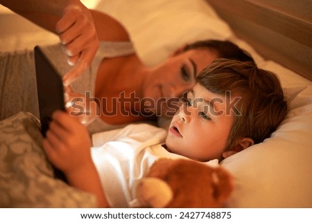 Mother, boy and tablet in bed at night for care, bonding or to watch movies together in family house. Mom, child and digital touchscreen for cartoon. film and streaming subscription in home bedroom
