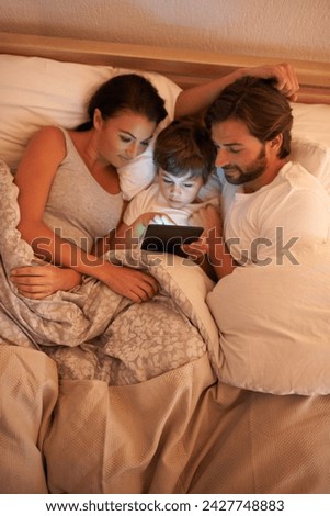 Parents, son and tablet in bedroom at night for app, bonding and above to watch movies in family house. Dad, mom and child in bed with touchscreen, cartoon or film with streaming subscription in home