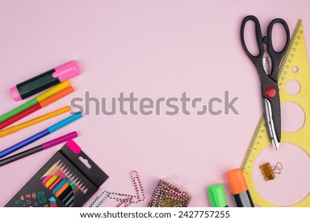 Back to school. Stationery on a pink table. Office desk with copy space. Flat lay