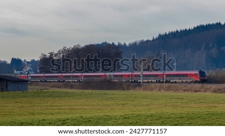 Taking on a passenger train with an electric locomotive Royalty-Free Stock Photo #2427771157