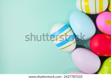 colorful pastel Easter eggs on green background copy space stock photo