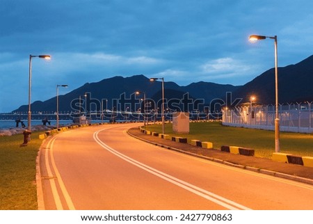 empty asphalt road at dusk in Hong Kong Royalty-Free Stock Photo #2427790863