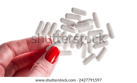 Close-up of a pile of white colored pills or capsules on isolated white background. . High quality photo