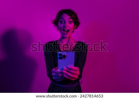 Photo portrait of lovely young lady hold excited device read news wear trendy overall garment isolated on neon light pink color background