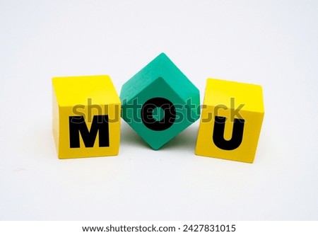 A coloured wooden block with word “MOU” on it.  MOU stands for “Memorandum of Understanding Agreement”