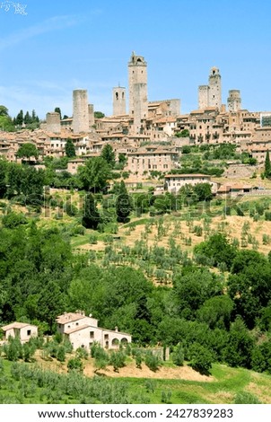 View to town across agricultural landscape, san gimignano, unesco world heritage site, tuscany, italy, europe