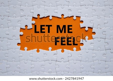 Feel symbol. Concept words Let me feel on white puzzle. Beautiful orange background. Psychology and let me feel concept. Copy space.