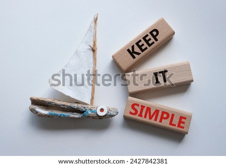 Keep it Simple symbol. Concept words Keep it Simple on wooden blocks. Beautiful white background with boat. Business and Keep it Simple concept. Copy space.
