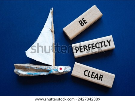 Be perfectly clear symbol. Concept words Be perfectly clear on wooden blocks. Beautiful deep blue background with boat. Business and Be perfectly clear concept. Copy space