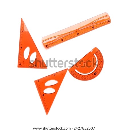 Orange straight and triangle plastic rulers with protractor on white background