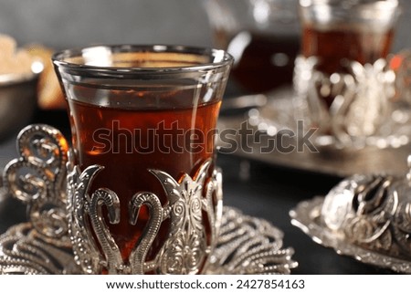 Traditional Turkish tea served in vintage tea set on table, closeup. Space for text
